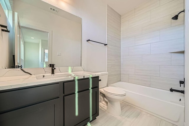 bathroom featuring toilet, visible vents, tub / shower combination, and vanity