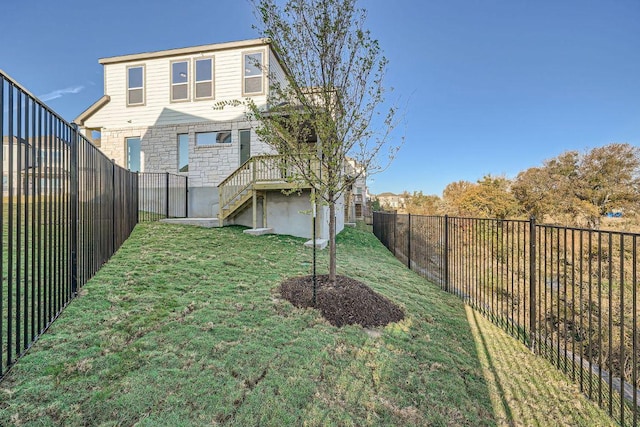 view of yard featuring a fenced backyard and stairs