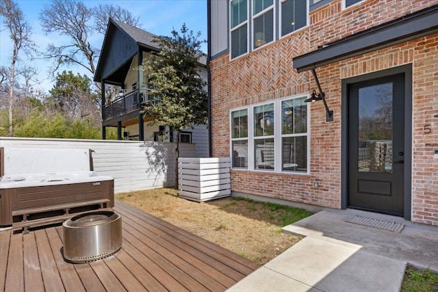 deck with fence and a hot tub