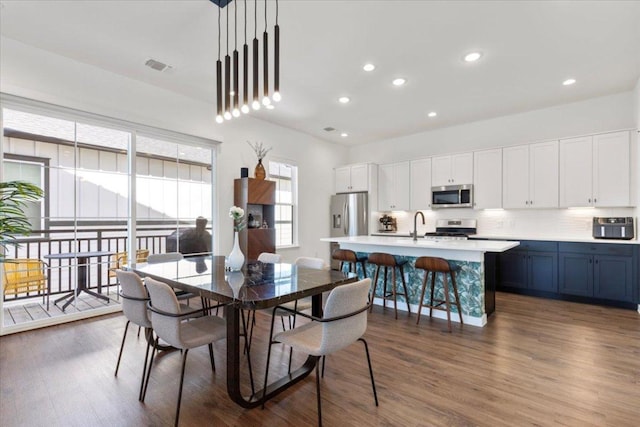 dining space with recessed lighting, dark wood-style flooring, and visible vents