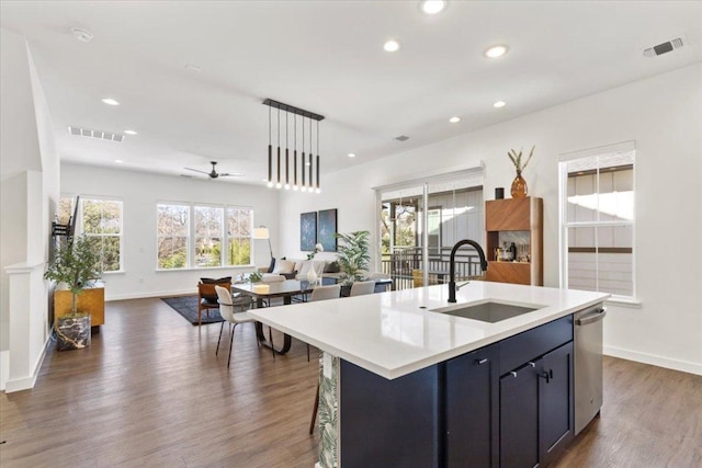 kitchen featuring visible vents, dark wood finished floors, dishwasher, open floor plan, and a sink