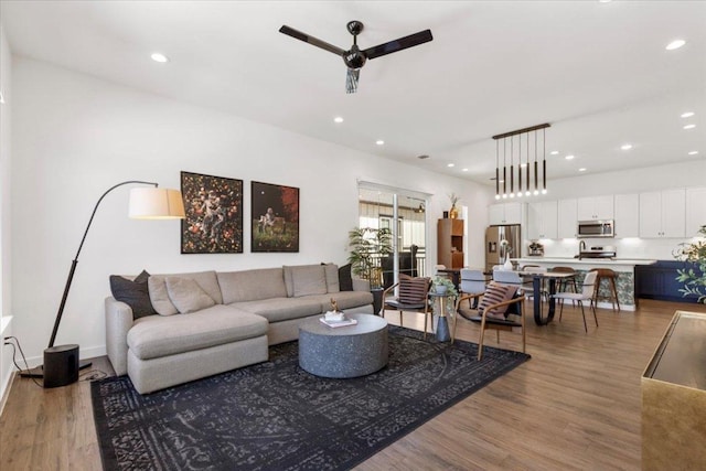 living area with recessed lighting, ceiling fan, and light wood finished floors