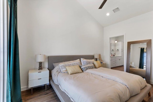 bedroom featuring baseboards, visible vents, lofted ceiling, wood finished floors, and a sink