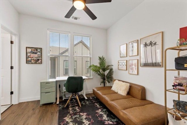 office area featuring visible vents, ceiling fan, baseboards, and wood finished floors