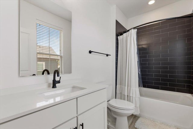 bathroom featuring shower / bathtub combination with curtain, vanity, and toilet