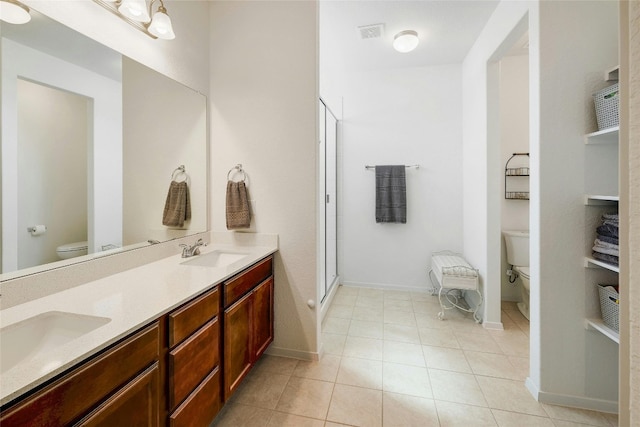 full bathroom featuring toilet, a stall shower, and a sink