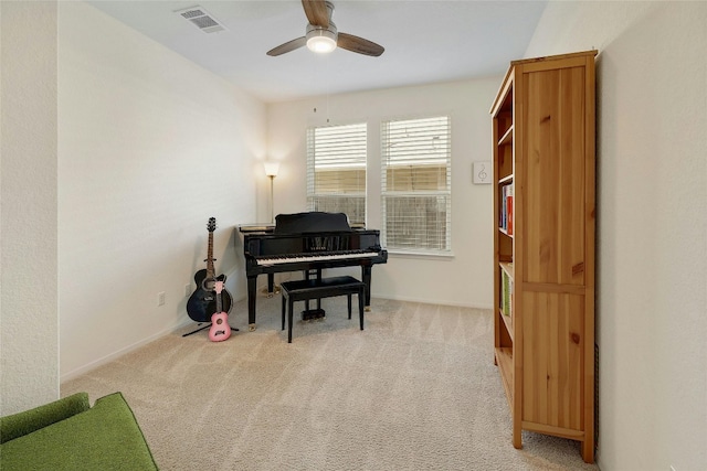 sitting room with visible vents, ceiling fan, light carpet, and baseboards