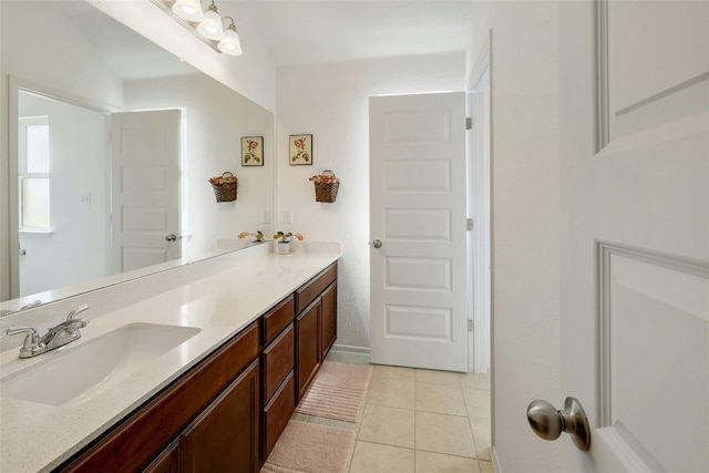 bathroom with double vanity, a sink, and tile patterned floors