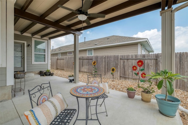 view of patio with a fenced backyard and a ceiling fan