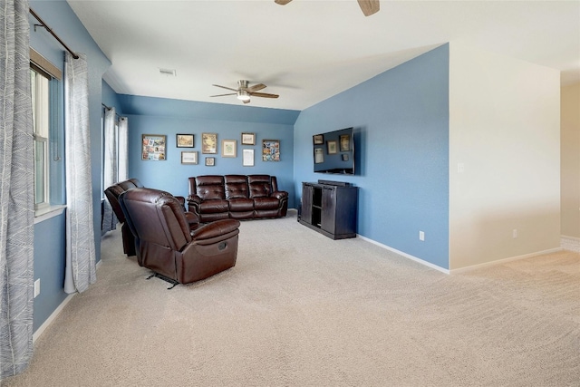 carpeted living area featuring visible vents, ceiling fan, and baseboards