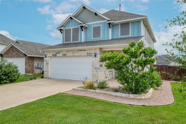 view of front of home with a garage, driveway, stone siding, fence, and board and batten siding