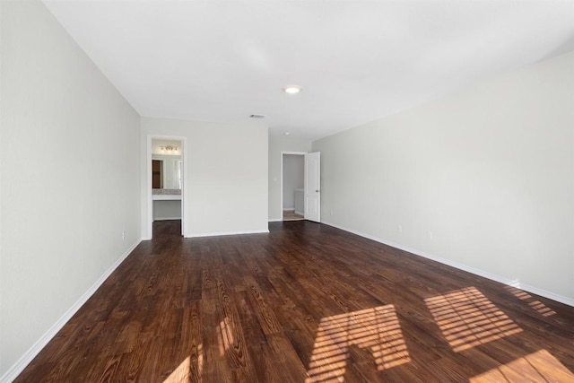 interior space with dark wood finished floors and baseboards