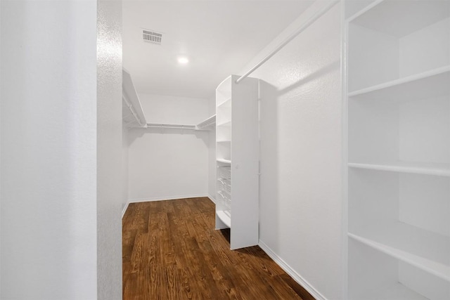 spacious closet featuring wood finished floors and visible vents