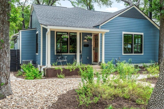 view of front of home featuring central AC and a shingled roof