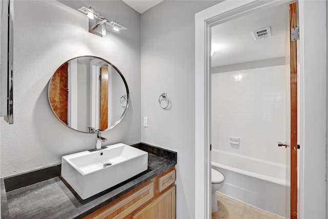 bathroom featuring toilet, tile patterned flooring, vanity, and visible vents