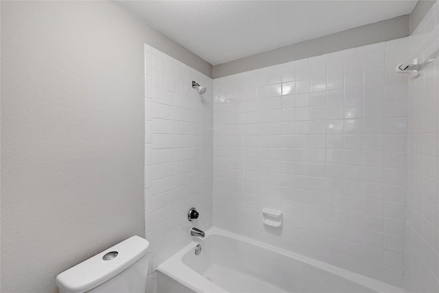 bathroom with toilet and bathing tub / shower combination