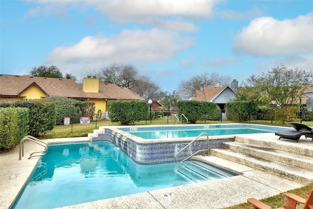 pool with fence and a patio