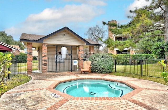 view of pool with fence and a hot tub