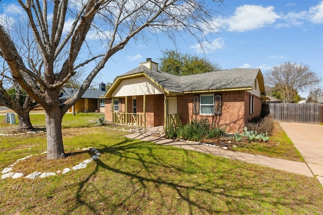 view of front of house featuring brick siding, a chimney, a porch, and a front yard