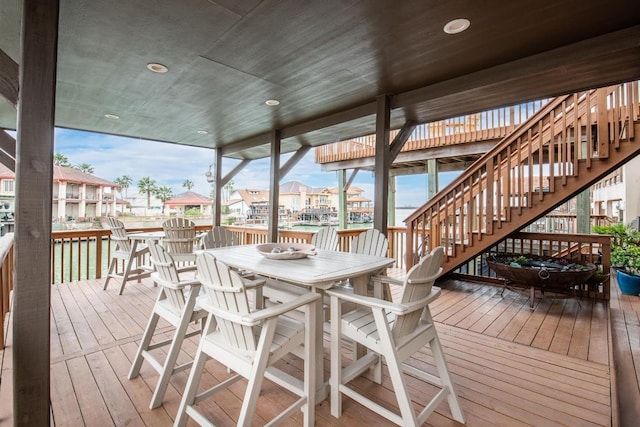 deck with stairway and outdoor dining space