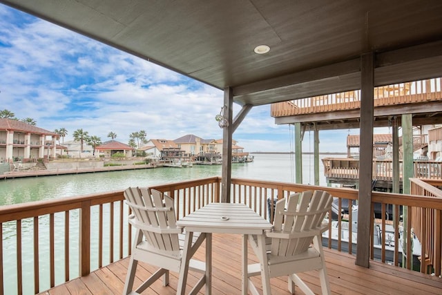 wooden deck featuring a residential view and a water view