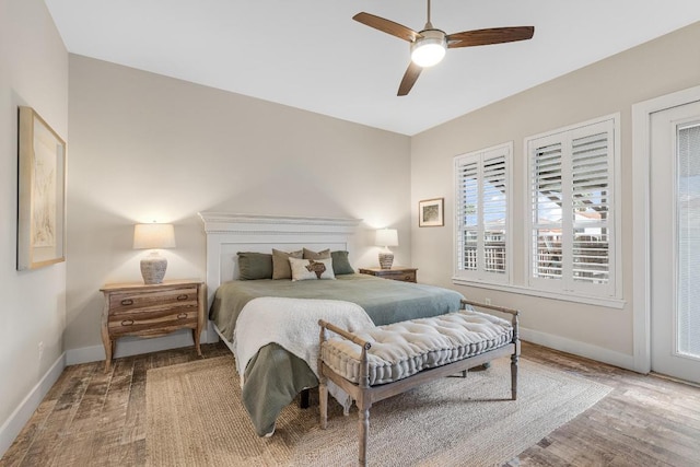 bedroom featuring a ceiling fan, baseboards, and wood finished floors