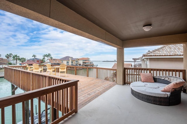 wooden deck with a water view and a residential view