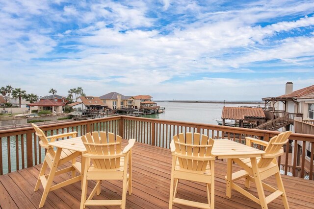 13525 Queen Johanna Ct, Corpus Christi, TX 78418 - wooden terrace featuring outdoor dining area and a water view