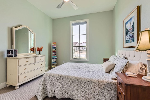 carpeted bedroom featuring a ceiling fan and baseboards