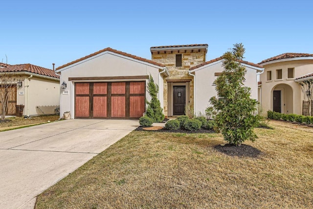 mediterranean / spanish-style home with concrete driveway, stone siding, a tile roof, an attached garage, and stucco siding