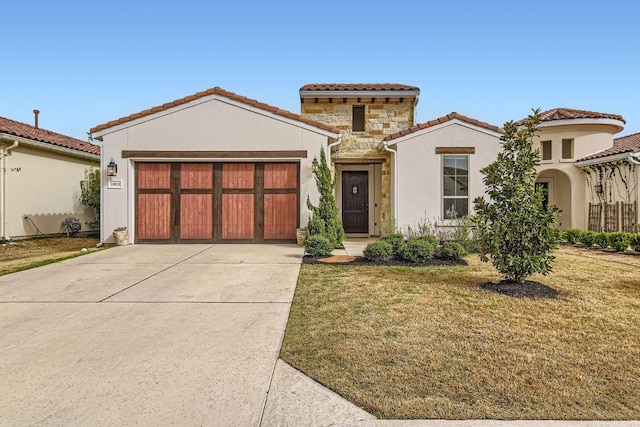 mediterranean / spanish-style home with a tile roof, concrete driveway, an attached garage, stone siding, and a front lawn