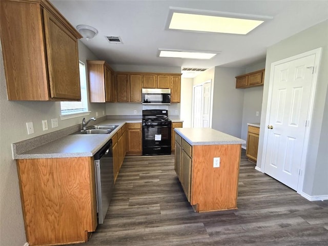 4533 Corran Ferry Loop, Austin, TX 78749 - kitchen with stainless steel appliances, dark wood finished floors, a kitchen island, brown cabinetry, and light countertops