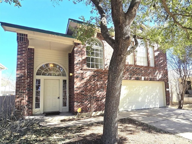 entrance to property with brick siding, concrete driveway, and an attached garage