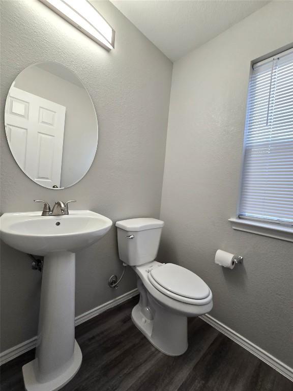 4533 Corran Ferry Loop, Austin, TX 78749 - bathroom featuring wood finished floors and toilet