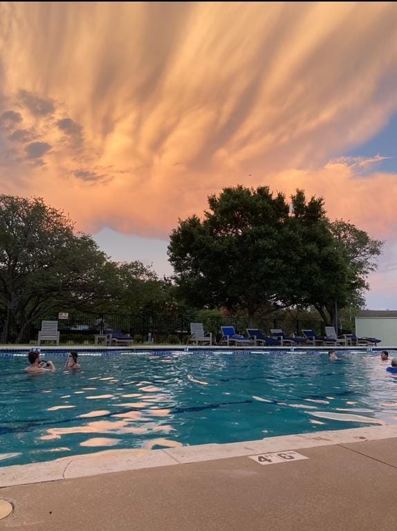 4533 Corran Ferry Loop, Austin, TX 78749 - pool at dusk with a community pool