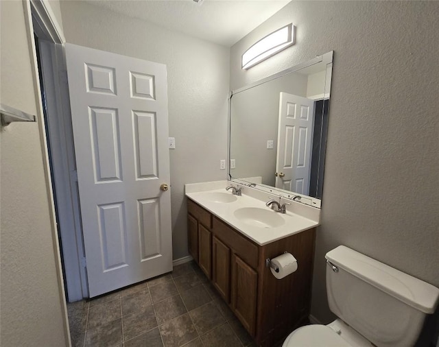 4533 Corran Ferry Loop, Austin, TX 78749 - bathroom featuring double vanity and a textured wall