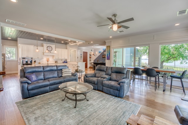 living area featuring light wood-style flooring, visible vents, and recessed lighting