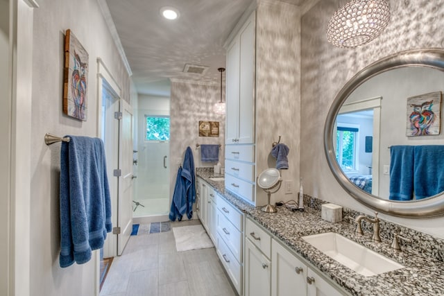 bathroom with visible vents, a stall shower, and vanity