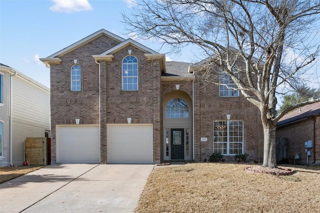 traditional-style house with concrete driveway, brick siding, and an attached garage