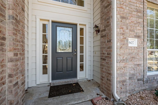 property entrance with brick siding