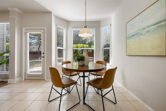 dining space with plenty of natural light, baseboards, and light tile patterned floors