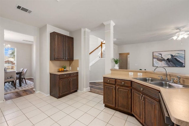 kitchen featuring light countertops, a sink, visible vents, and dishwashing machine