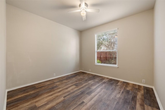 empty room with dark wood-style floors, baseboards, and a ceiling fan