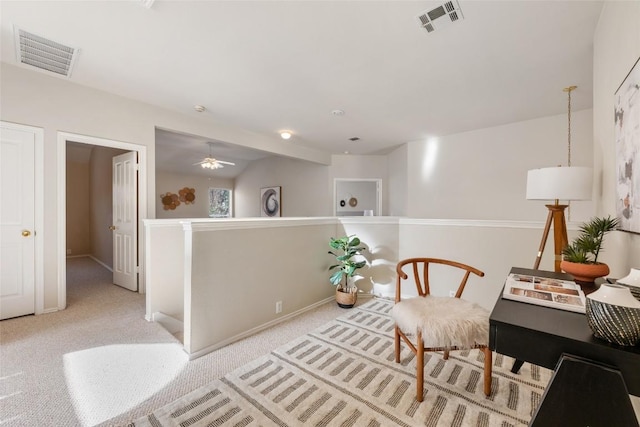 sitting room featuring a ceiling fan, baseboards, visible vents, and carpet flooring