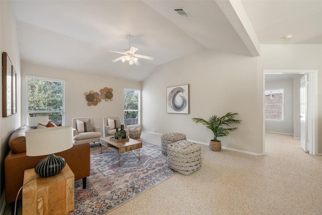 carpeted living room featuring lofted ceiling, baseboards, visible vents, and ceiling fan