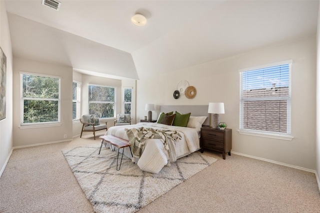 bedroom featuring lofted ceiling, baseboards, visible vents, and carpet flooring