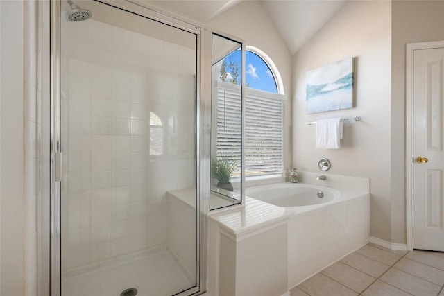 bathroom with lofted ceiling, a garden tub, a shower stall, and tile patterned floors