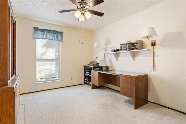 office area with light carpet, ceiling fan, a textured ceiling, and baseboards