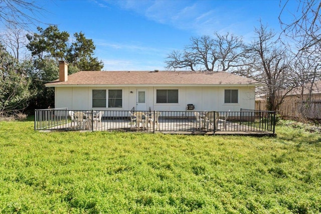 rear view of property with a yard, a patio area, fence, and a chimney