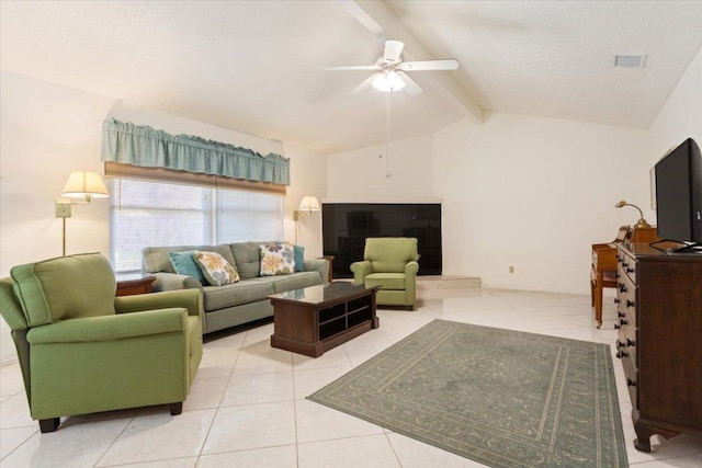 living area with lofted ceiling with beams, a textured ceiling, a ceiling fan, and tile patterned floors